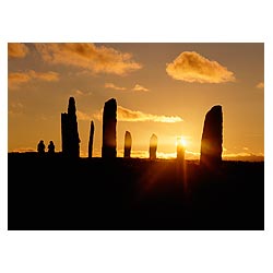 Standing stone circle - People sitting watching a sunset holiday tourists uk visiting scotland women  photo
 