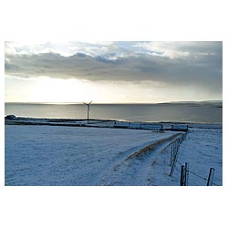 Scapa Flow - Farmhouse small wind turbine snow covered farm field house scotland  photo 