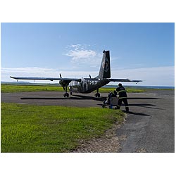 Loganair aircraft - Baggage handler loading Britten Norman Islander plane island small aircraft  photo 